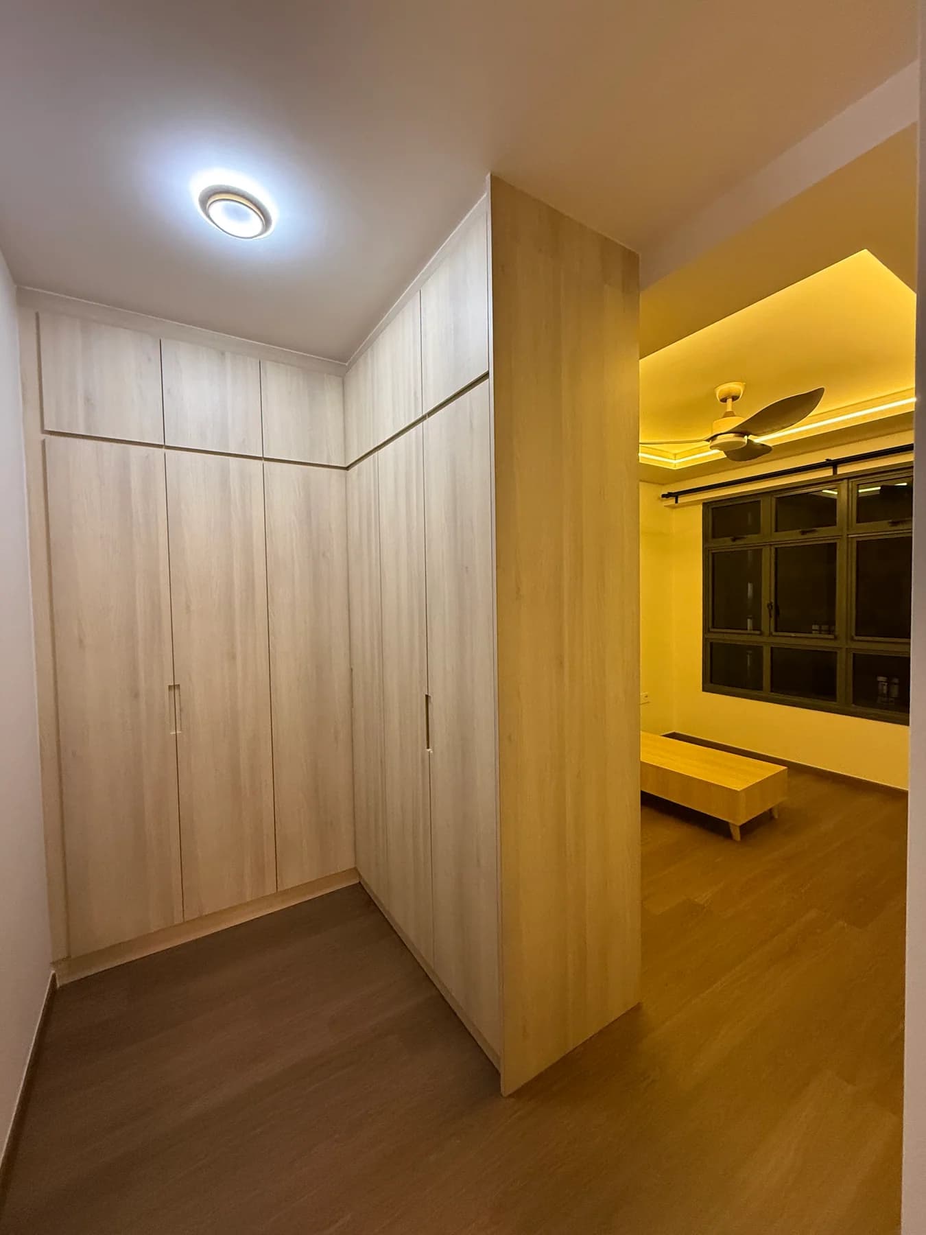 L-shaped built-in bedroom wardrobe beside vinyl flooring