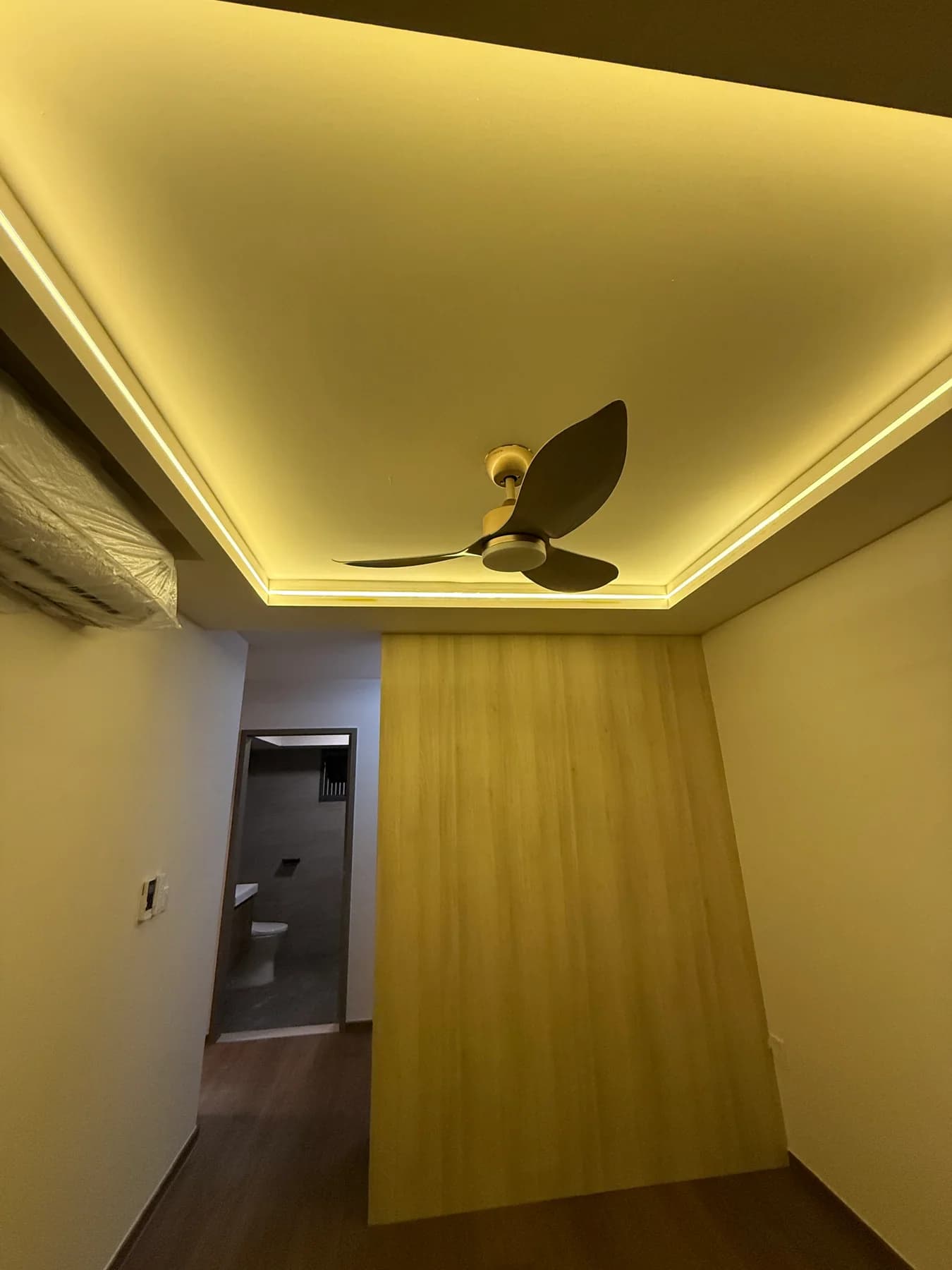 Master bedroom with vinyl flooring and illuminated L-box ceiling
