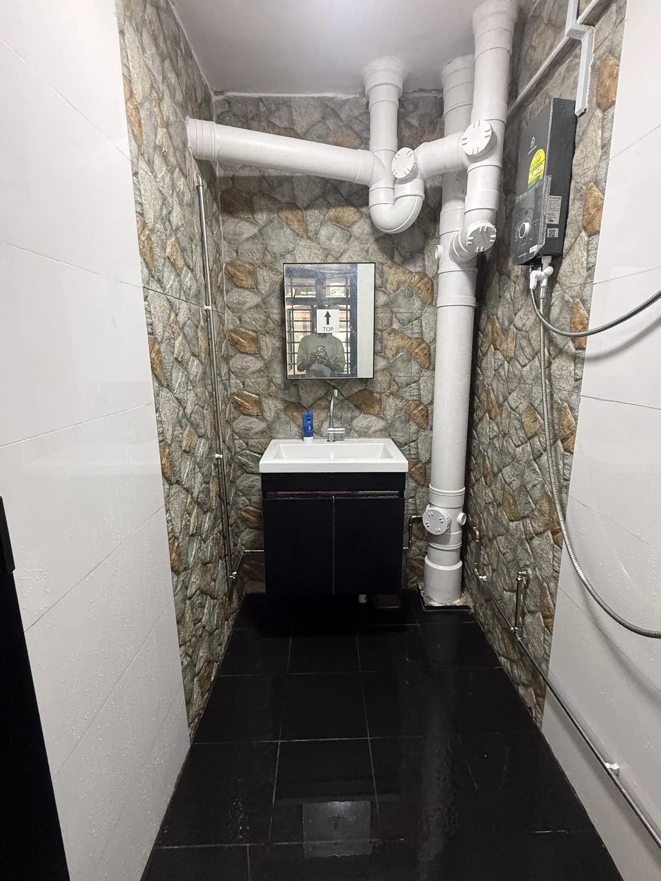 Completed bathroom with contrasting stone-look and white tiles