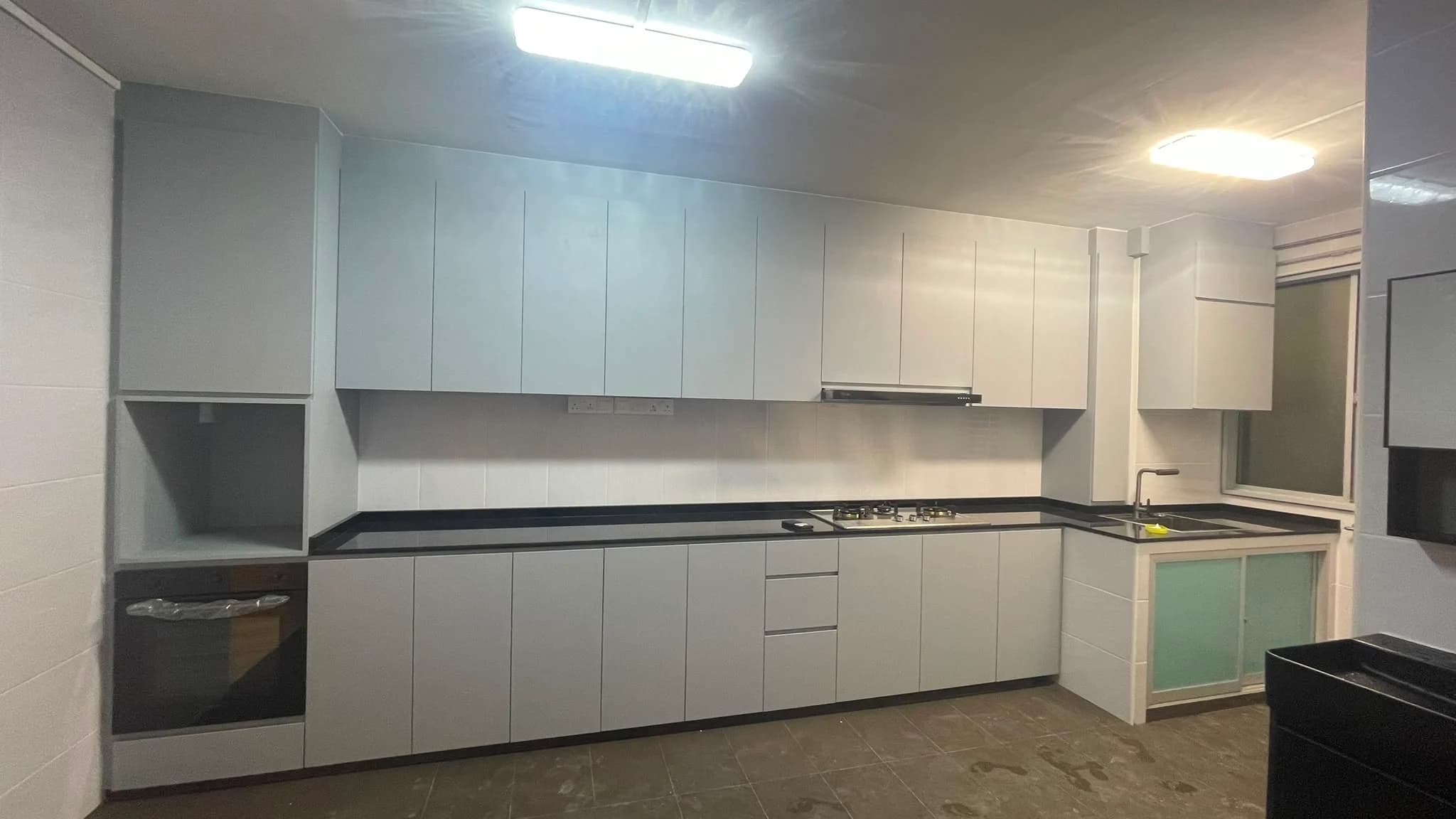 Completed kitchen with white cabinetry and dark quartz countertop