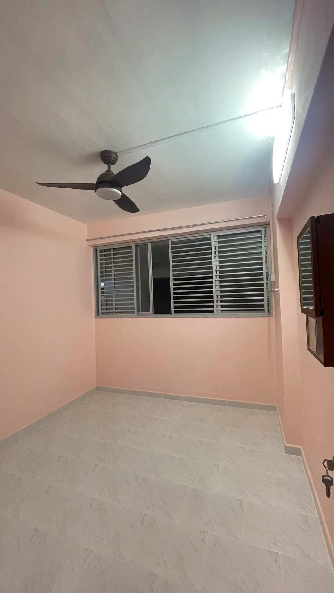 Completed bedroom with repainted walls, tiled floor and ceiling fan