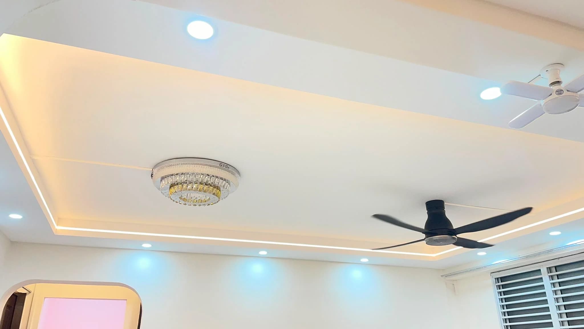 L-box ceiling detail with LED strip lighting and ceiling fans