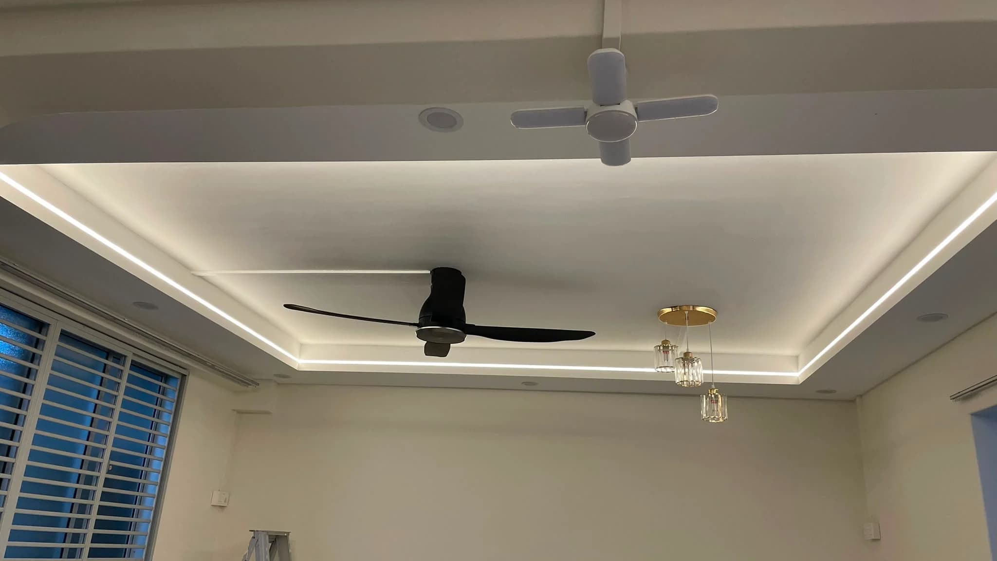 Completed L-box ceiling with recessed lighting in the living and dining area