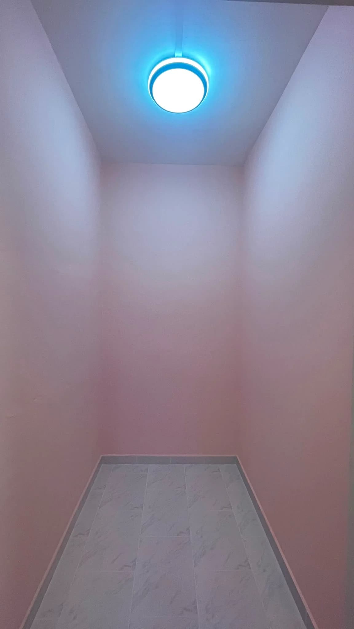 Completed relocated storeroom with painted walls and tiled floor