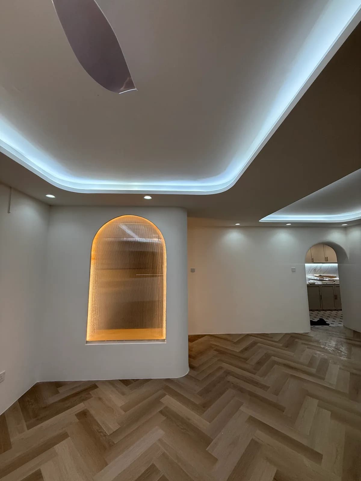 Completed living area with feature wall and ceiling lighting