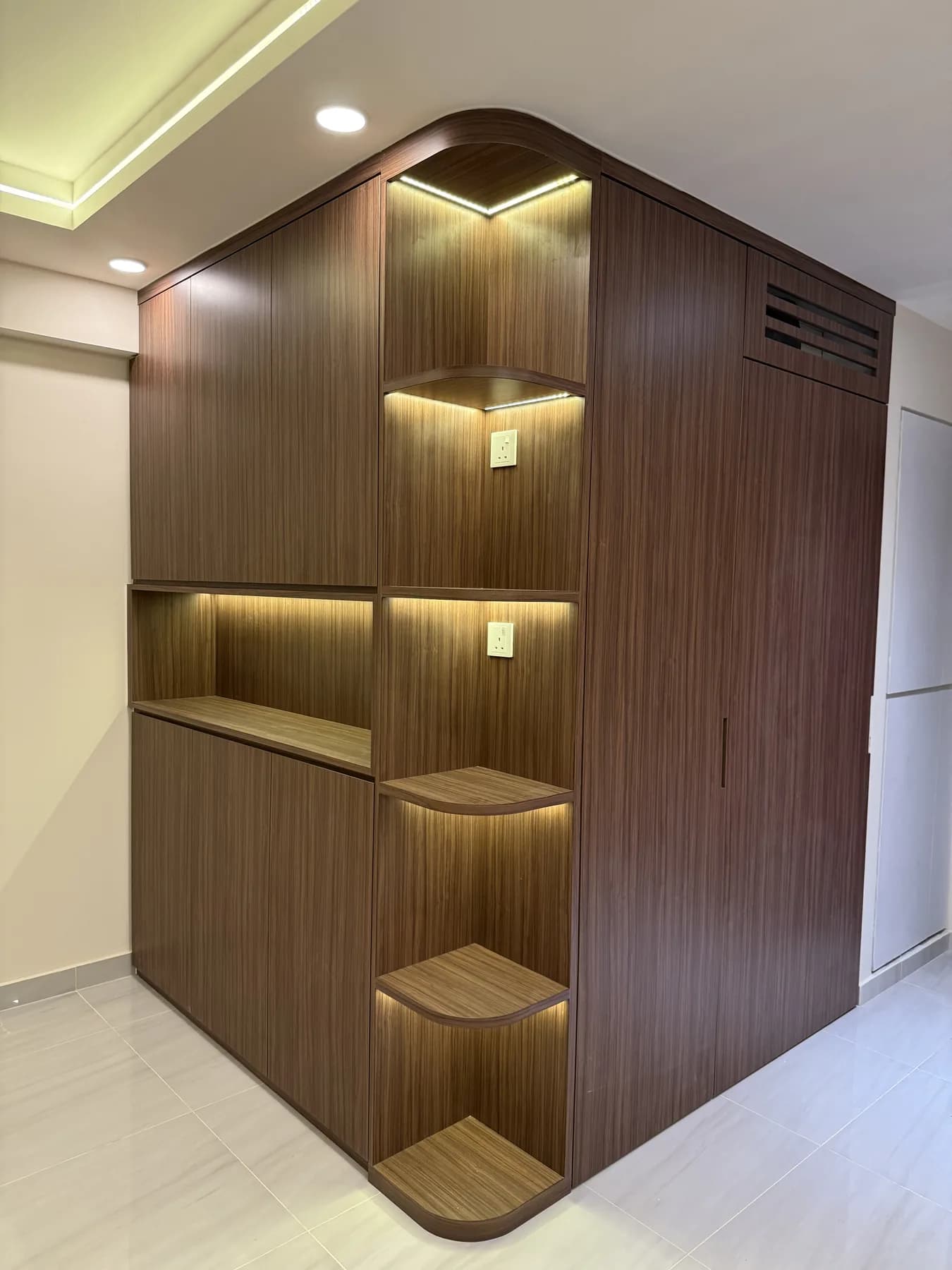 Full-height curved bomb-shelter cabinet with display lighting at the Bartley Walk BTO