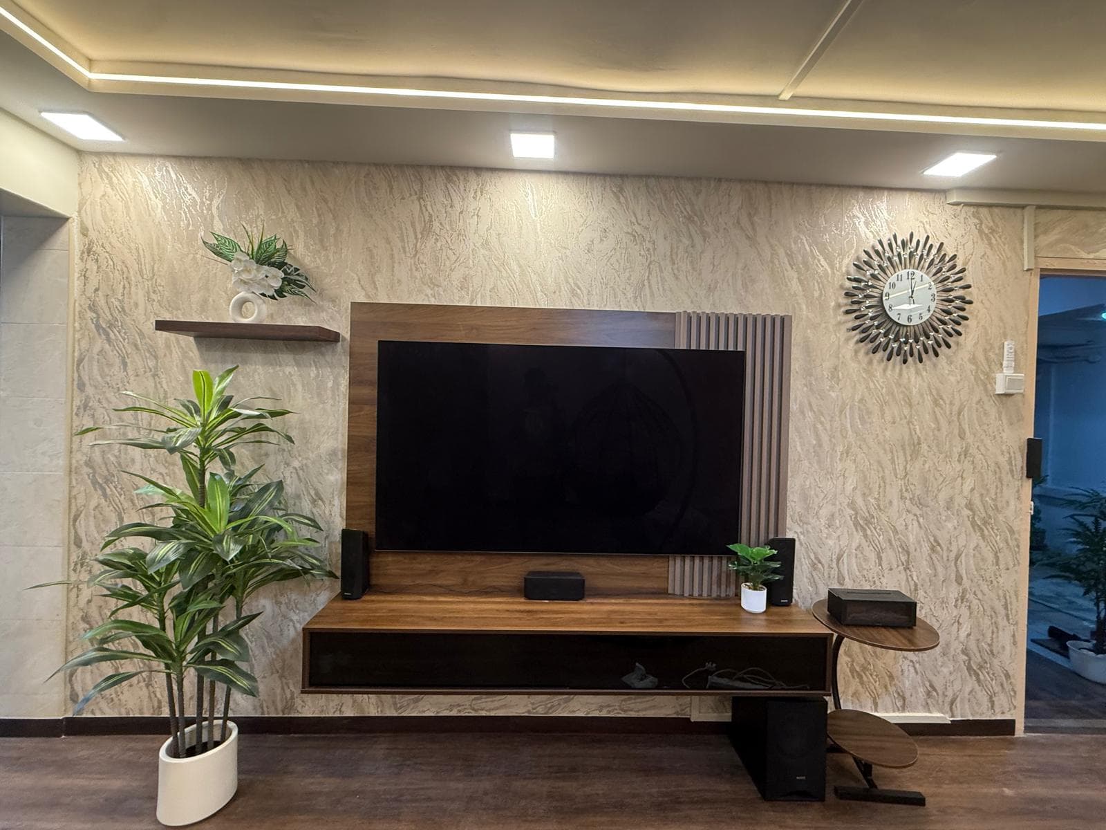 Completed living room with a fitted television feature wall and integrated lighting